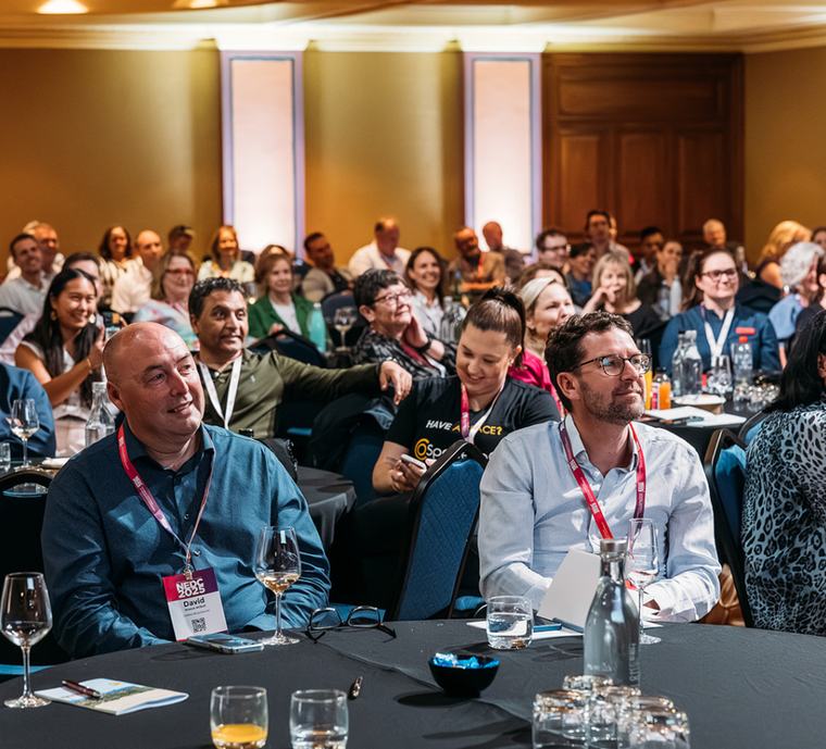 Delegates at a table during a conference session