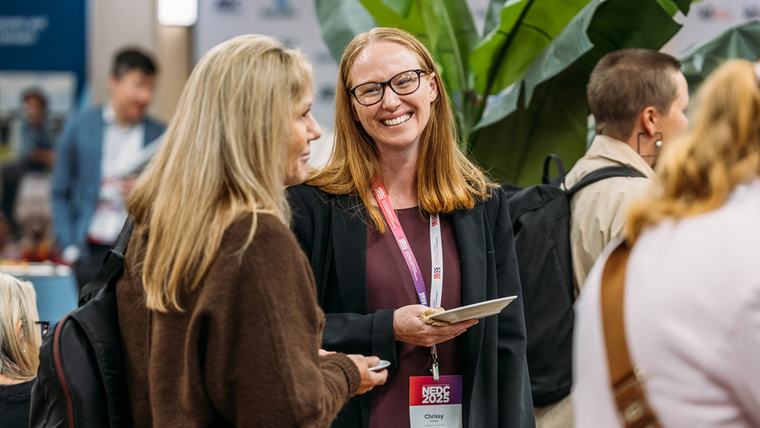 Two delegates in conversation during a break